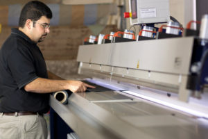 employee cutting fabric for custom drapes